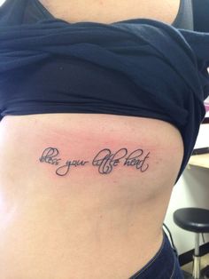 a woman's stomach with the words be your own tattoo on her lower back