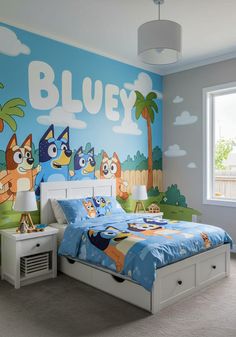 a child's bedroom decorated in blue and green with cartoon characters on the wall