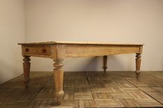 a wooden table sitting on top of a tiled floor