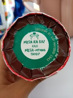 a close up of a person holding a piece of chocolate with the words mesaka bar on it