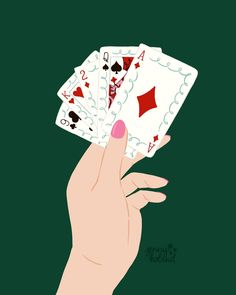 a person's hand holding four playing cards