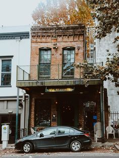 a black car parked in front of a building