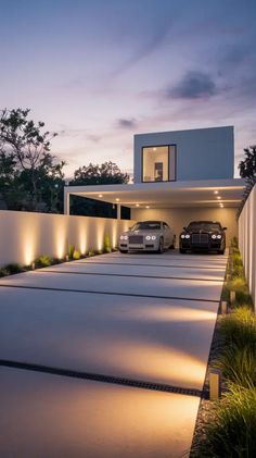 two cars parked in front of a modern house