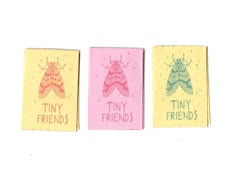 three small matchesticks with tiny friends written on them in pink, yellow and green