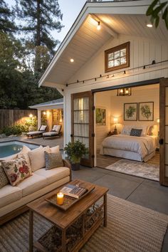 a living area with couches, tables and a swimming pool in the back yard