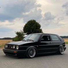 the black car is parked on the side of the road