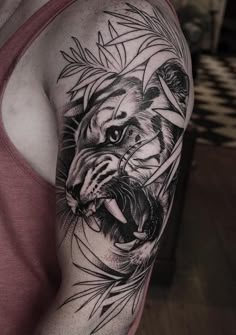 a man with a tiger tattoo on his arm