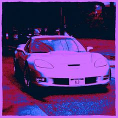 a white sports car is parked on the street