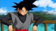 the young gohan is standing in front of a wooden fence with his hands on his hips