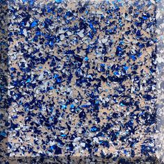 blue and silver speckles are scattered on the ground in this square shape pattern