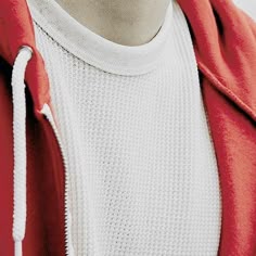 a person wearing a red jacket and white shirt