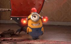 a minion standing in front of a red chair with its eyes open and lights on