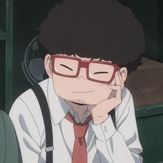 a man wearing glasses and a tie with his hand to his face