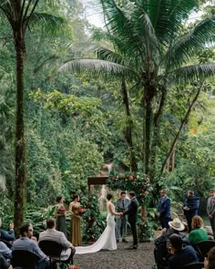a couple getting married at their wedding in the jungle