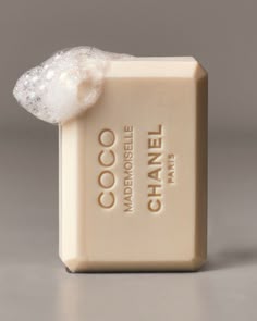 a close up of a soap bar on a gray surface with a white object in the middle