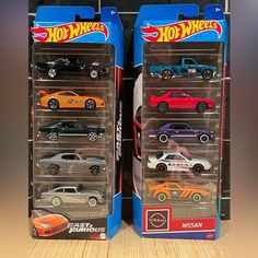 two boxes of hot wheels cars are shown