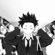 a man in a suit and tie holding his hands to his ears