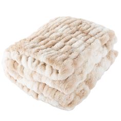 three blankets stacked on top of each other in beige and white colors, one is folded up