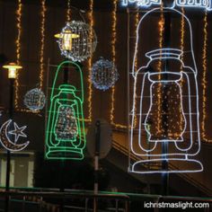 christmas lights and decorations on display in front of a building