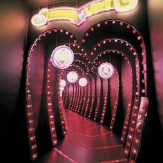 an illuminated tunnel in the shape of a heart, with lights on either side and below