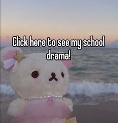 a white teddy bear sitting on top of a beach next to the ocean with text that reads, click here to see my school drama drama