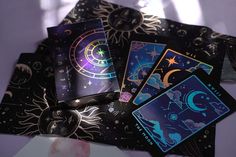 four different tarot cards on top of each other with the sun and moon in them