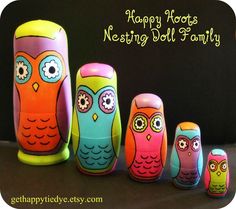an image of colorful nesting owls on black background with caption happy hoot's nesting doll family