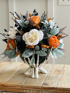 an arrangement of flowers in a vase on a table