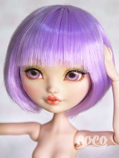 a close up of a doll with purple hair