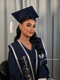 a woman in a graduation gown and cap