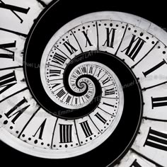 a spiral clock with roman numerals on it