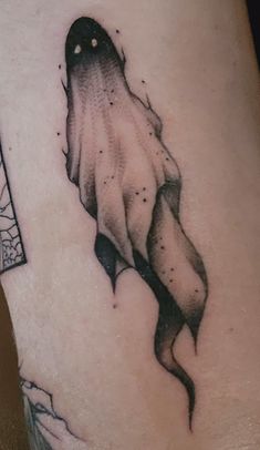 a black and white tattoo on the leg of a woman