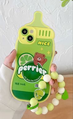 a person holding up a cell phone case with gummy bears on the front and side