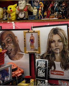 there are many pictures on the wall in this room, including one with a woman's face