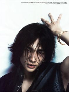 a young man with black hair and piercings on his head posing for a magazine cover