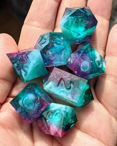 four dices in the palm of someone's hand with space and stars on them