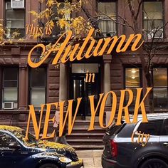 two cars parked in front of a building with the words autumn in new york on it