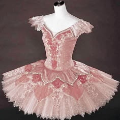 a pink ballerina dress is displayed on a mannequin's headdress