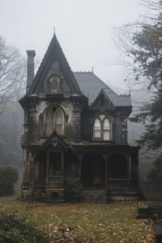 an old abandoned house in the woods on a foggy day