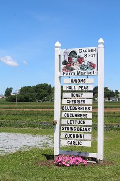 a sign in front of a field that says garden spot on it's side