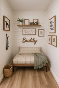 a small room with some pictures on the wall and a couch in front of it