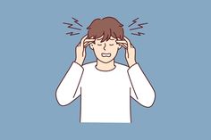 a man holding his head with both hands