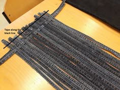 there is a piece of fabric that has been sewn together on a wooden table