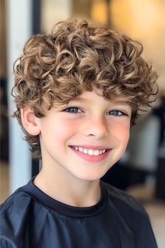 Smiling boy with a curly haircut featuring soft, bouncy curls.