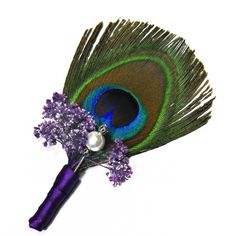 a purple flower and peacock feather boutonniere on a white background with pearls