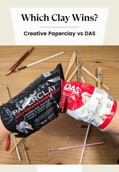 a person's hand holding a bag of paperclaws with the words which clay wins?