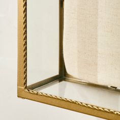 a gold framed mirror hanging on the wall