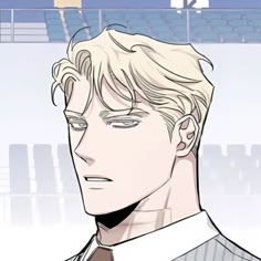 a man with blonde hair wearing a shirt and tie in front of an empty stadium