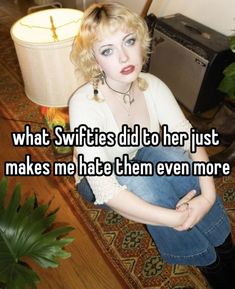 a woman sitting on the floor with her arms crossed and texting what swiffies did to her just makes me hate them even more