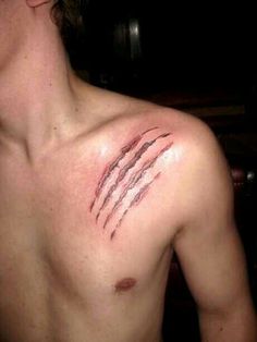 a man with tattoos on his chest and shoulder